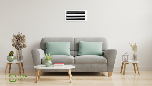 A white GREEN VENT linear slot diffuser is seamlessly installed on the wall above a gray sofa in a modern, minimalist living room
