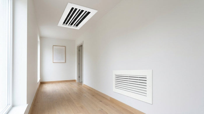 Supply linear slot diffuser on the ceiling and return air grille on the wall of a hallway